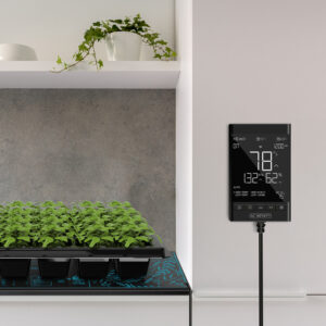 AC Infinity Controller 79 PRO in action, monitoring climate conditions above a tray of seedlings in an indoor garden