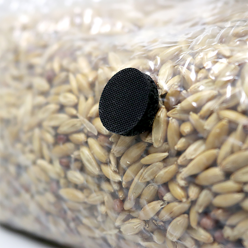 Black filter patch on a bag of grain showing its application in mushroom cultivation